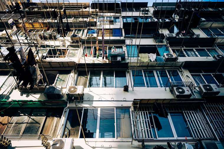 Apartment façade with windows, balconies and air-conditioning units