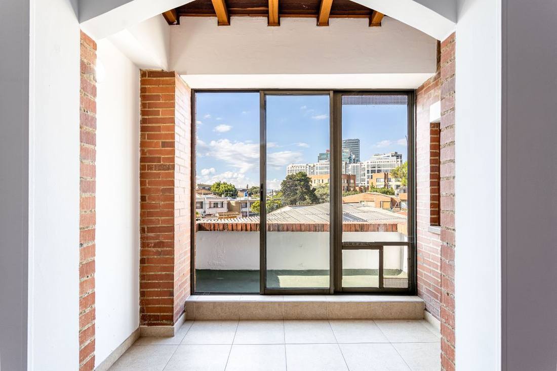 Apartment balcony viewed through a large glass door