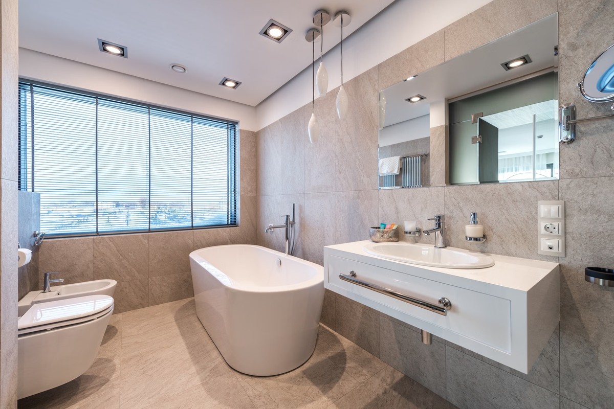Modern bathroom with adjustable blinds covering a large window