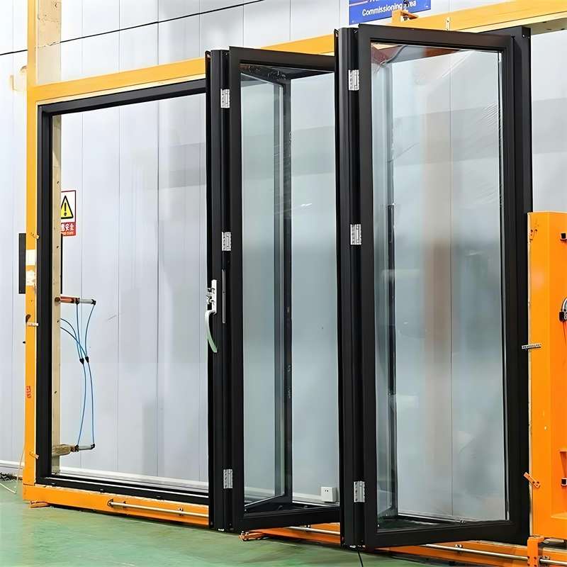 Black framed folding glass door panels during factory commissioning