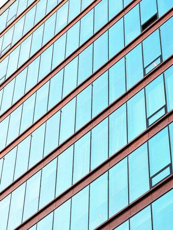 Close-up of repeated blue-tinted office windows