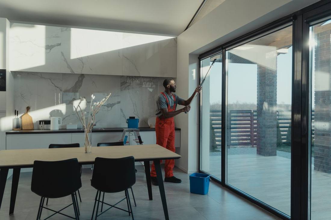 Professional cleaning large glazed doors from inside