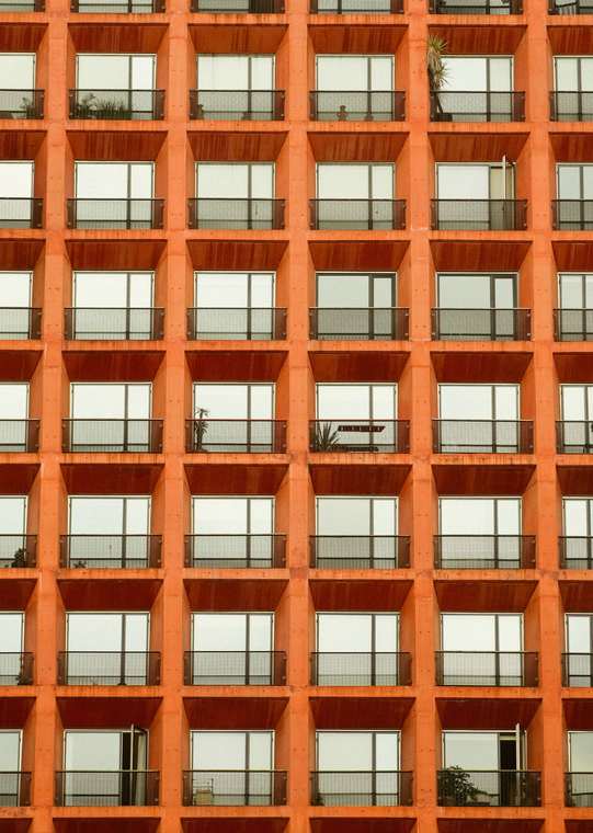 Repeated windows across a modern apartment building façade