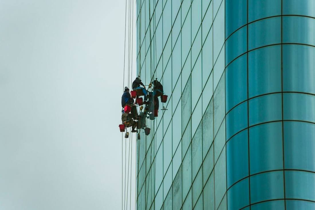 Rope-access workers on a tall glazed building