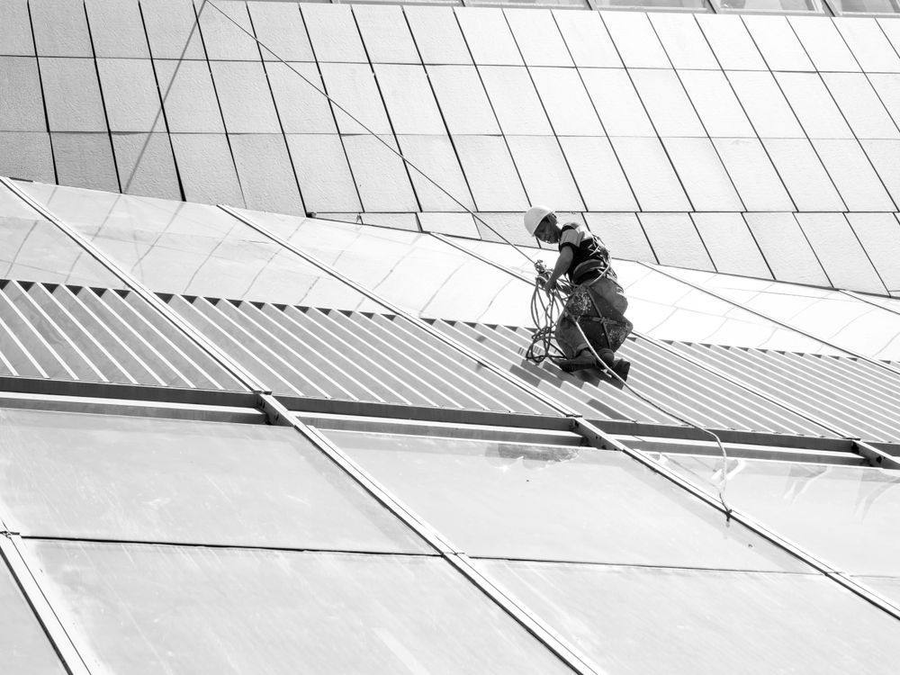 Maintenance worker on a skyscraper glass façade