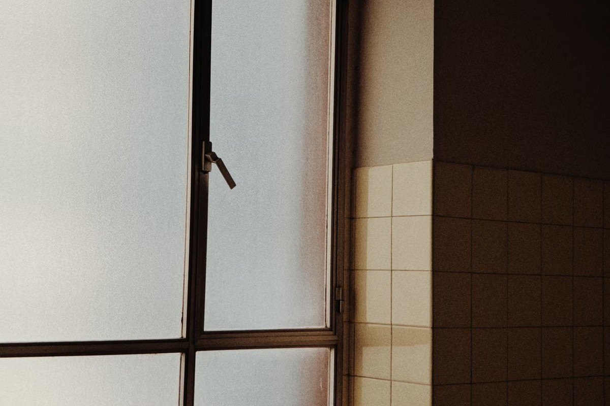 Frosted glass window diffusing light in a tiled interior