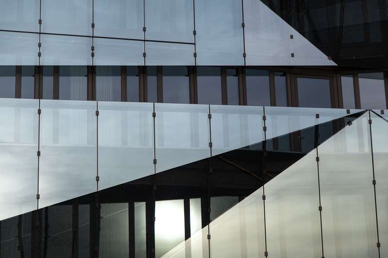 Commercial glass façade with framed and point-supported panels