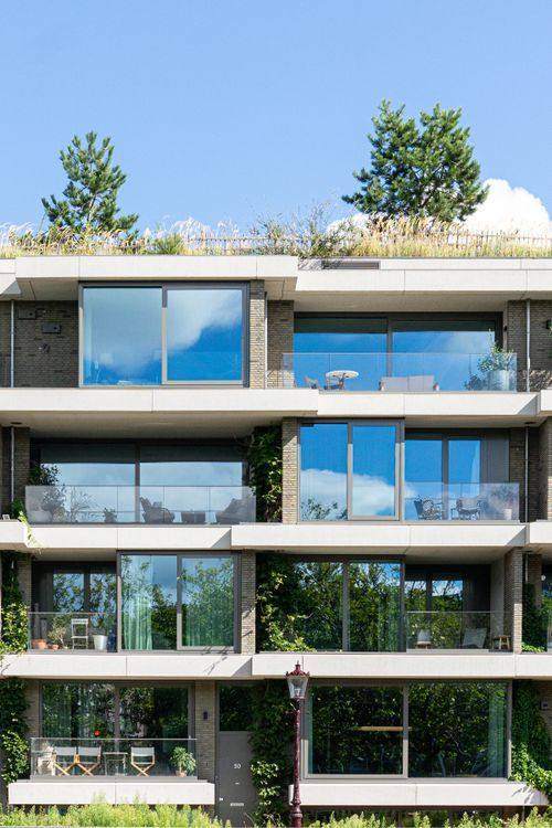 Contemporary apartment building with large windows and green roofs