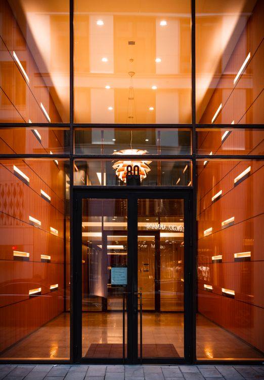 Commercial glass door integrated into a glazed wall