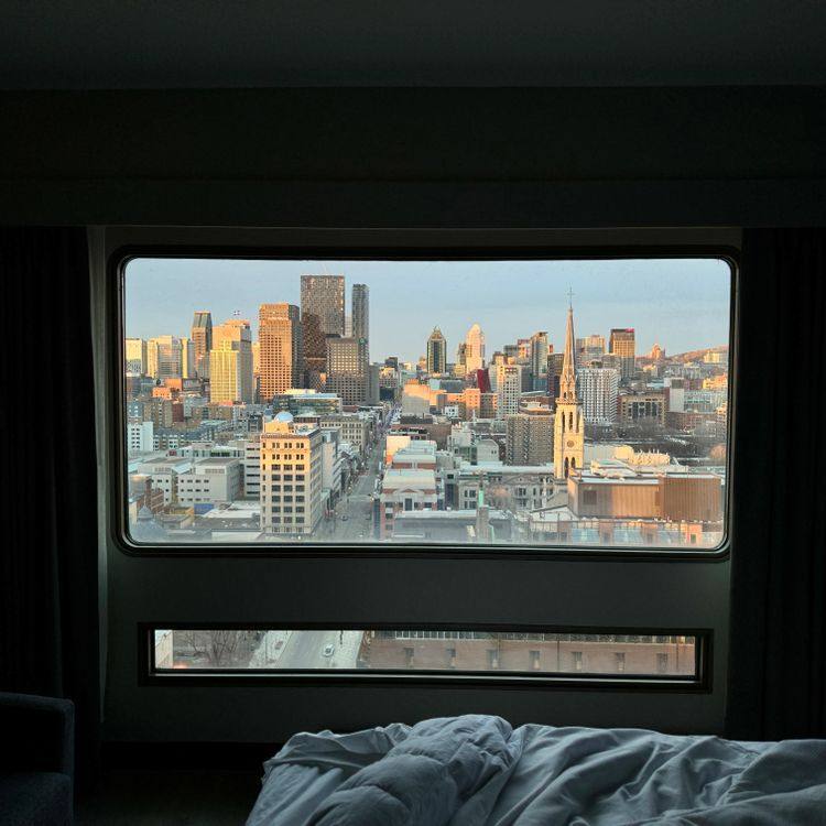City skyline framed by a large hotel-room window