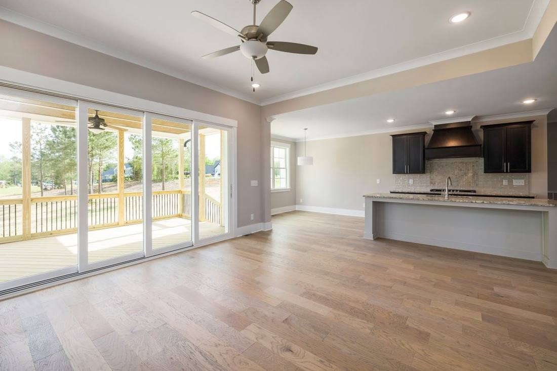 Wide glazed doors opening to a residential veranda