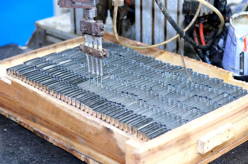 Industrial machine processing batches of small metal components