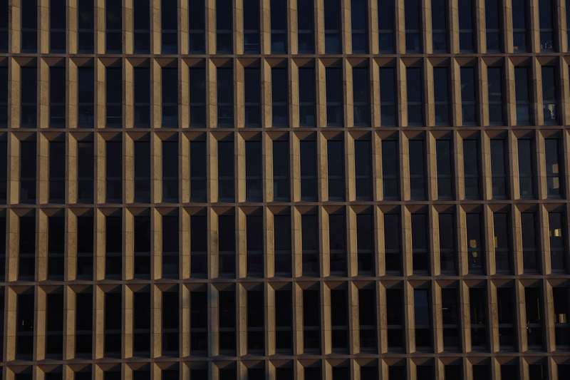 Repetitive grid of windows across a multi-storey commercial façade