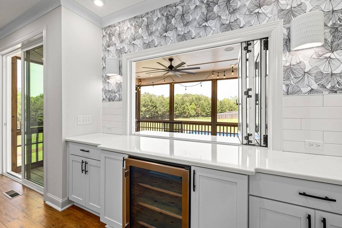 Modern kitchen beside a wide glazed patio opening