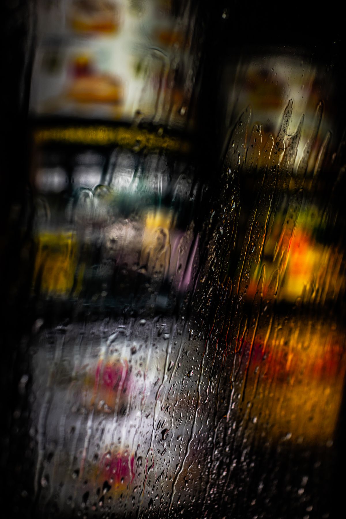 Close-up of rainwater running down a window pane