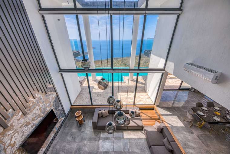 Luxury villa interior with panoramic windows overlooking the sea