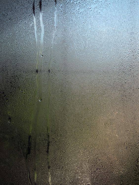 Water droplets covering a glass surface