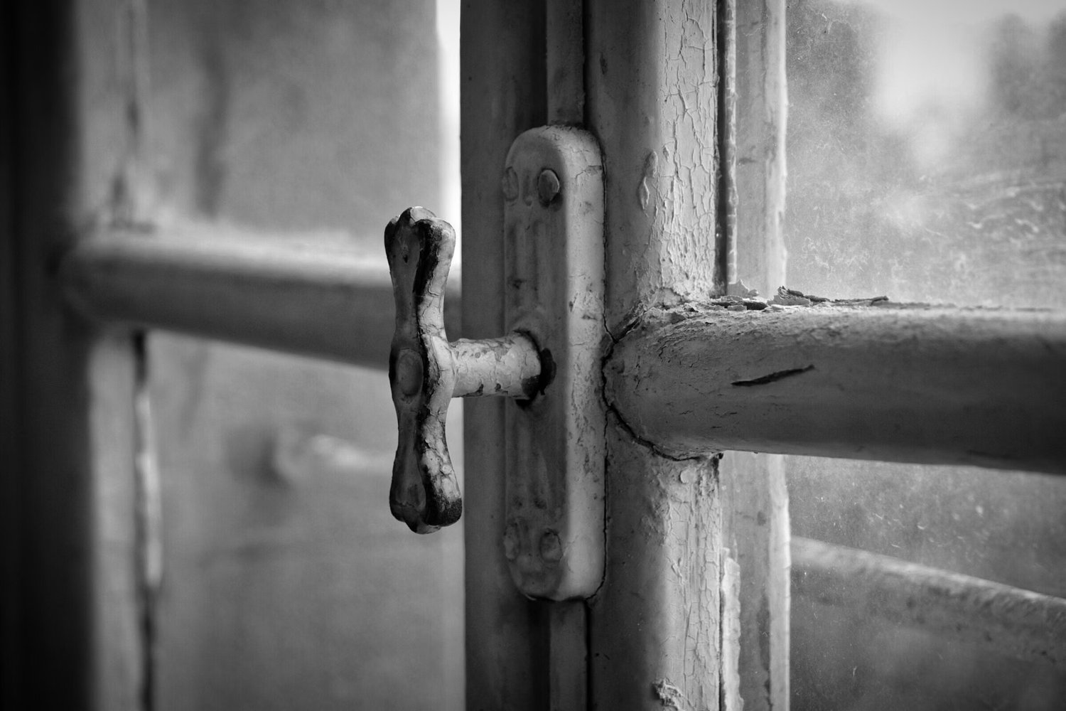 Close-up of a metal handle on a window frame