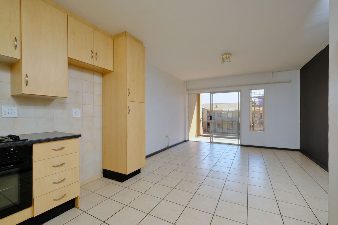 Modern apartment interior with tiled floor and balcony access