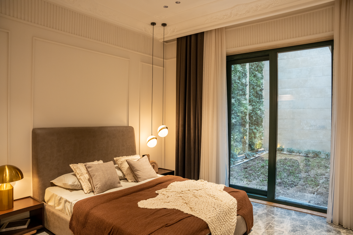 Bedroom with large sliding glass doors overlooking a garden