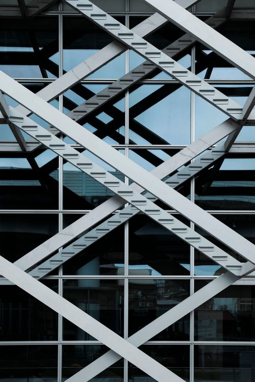 Glass curtain wall intersected by a geometric steel grid