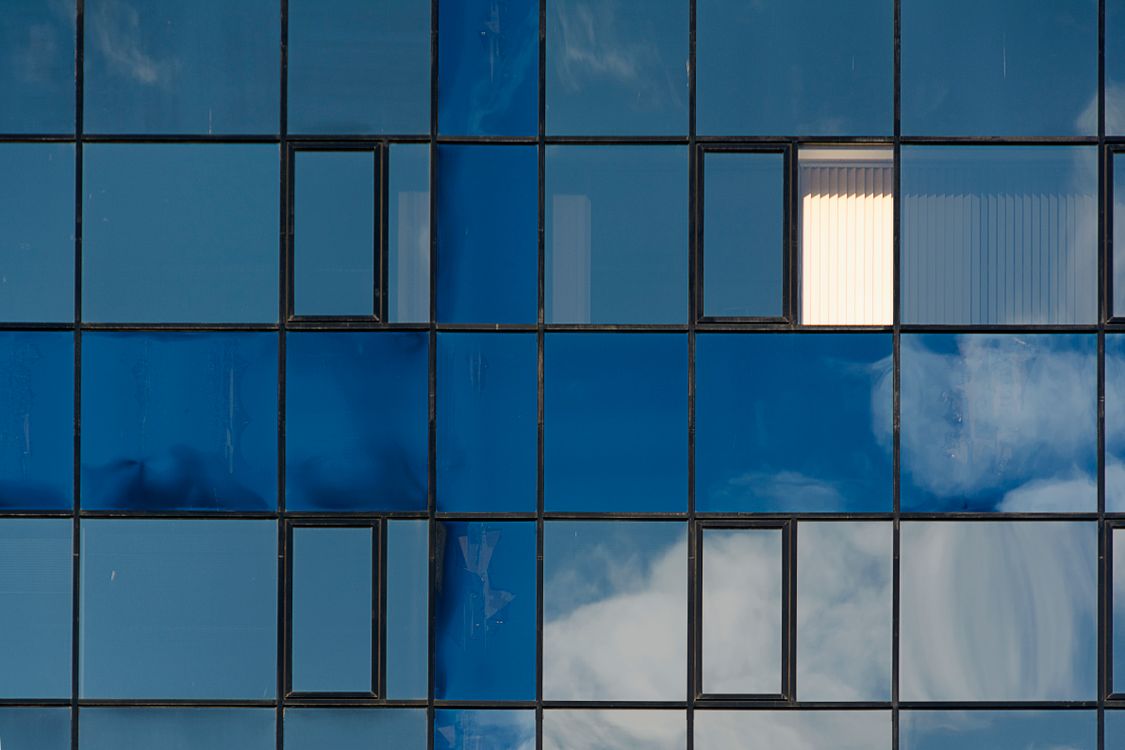 Close view of a blue reflective glass façade grid