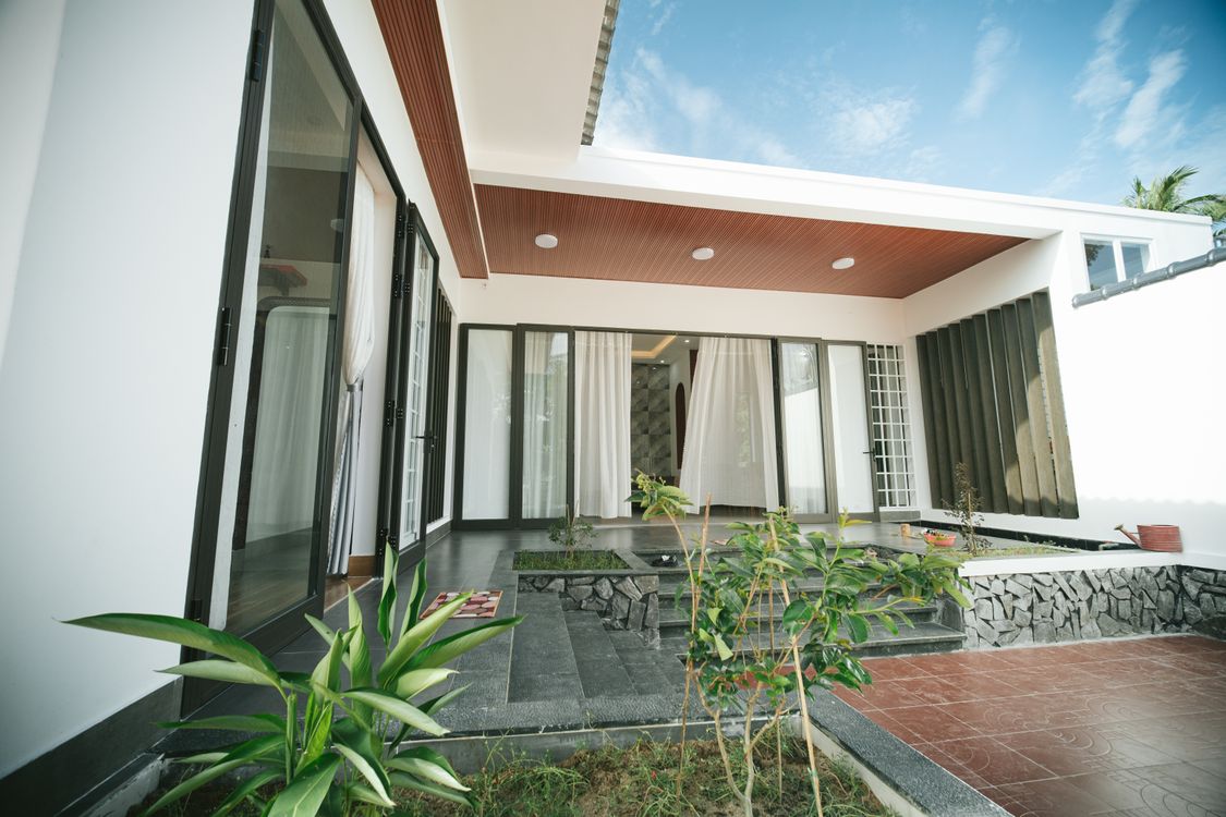 Contemporary house terrace with large glass doors and plants