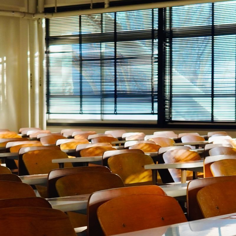 Classroom desks beside window blinds