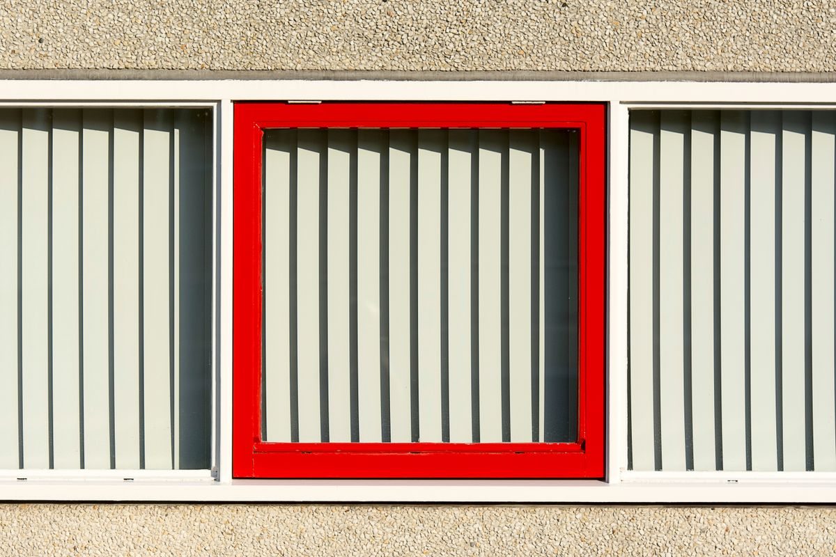 Red aluminium window frame on a facade