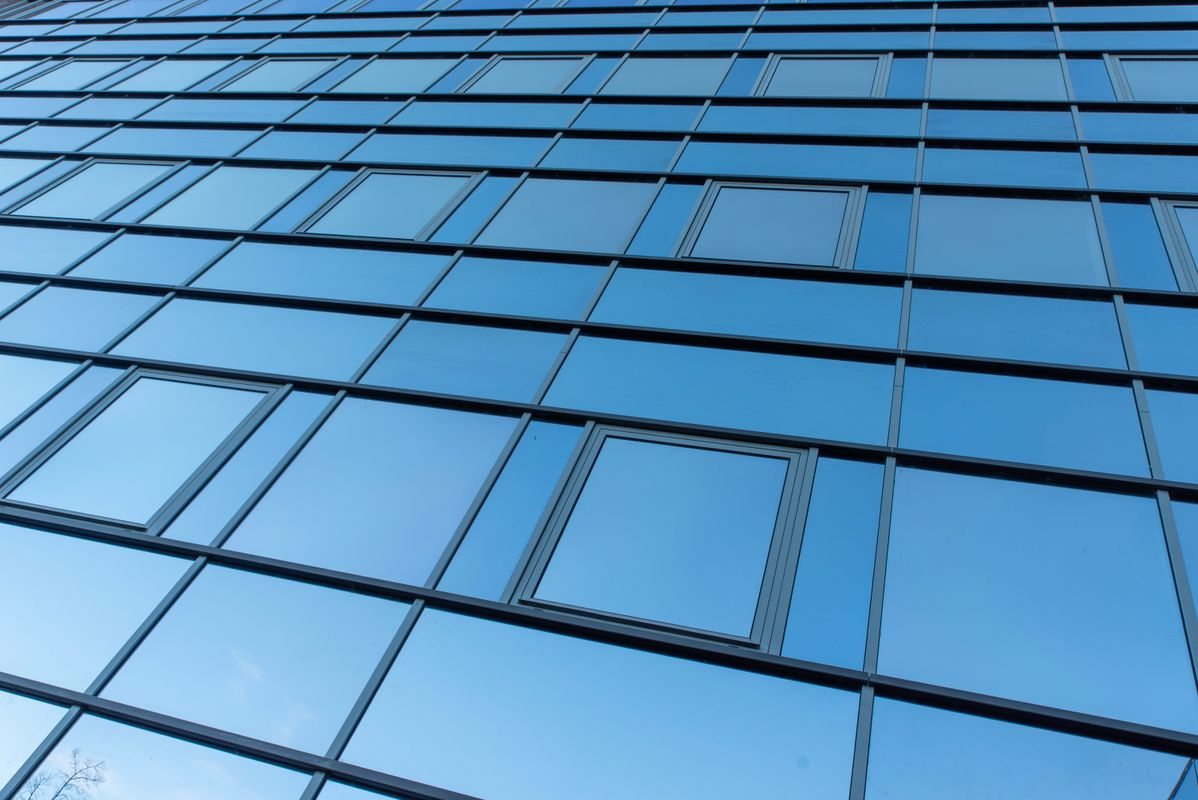 Reflective blue glass facade of a modern office