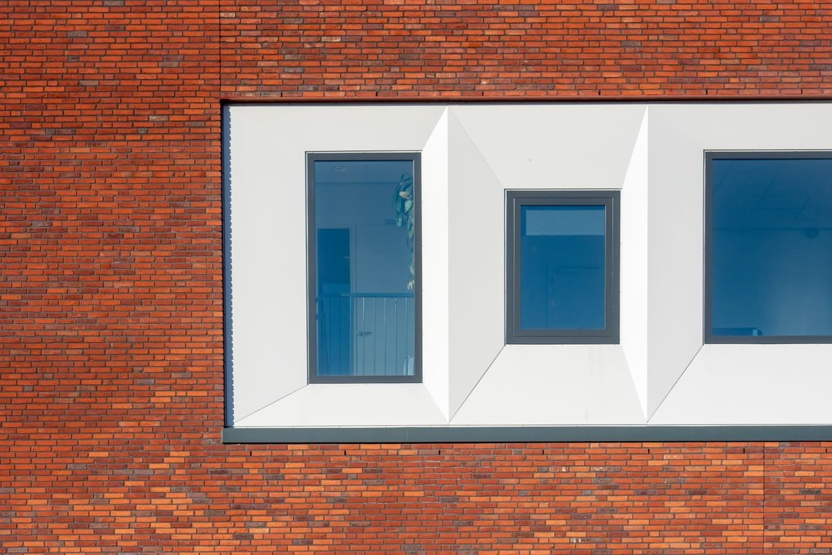 Brick and glass facade with geometric windows