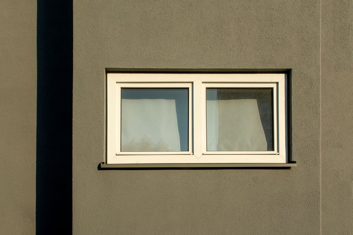 Sunlit window on a concrete facade