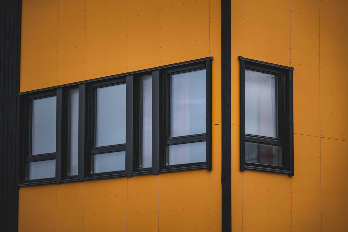Yellow building facade with dark-framed windows