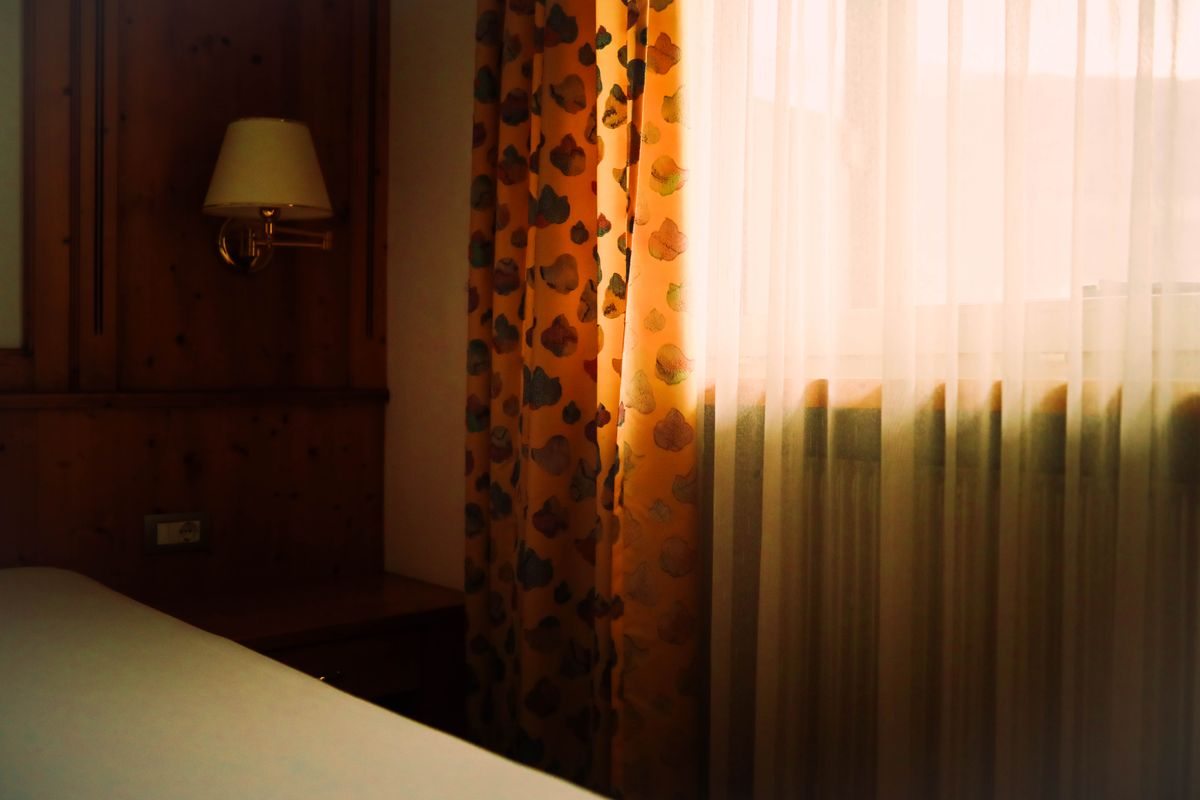 Hotel bedroom with sunlight through a window