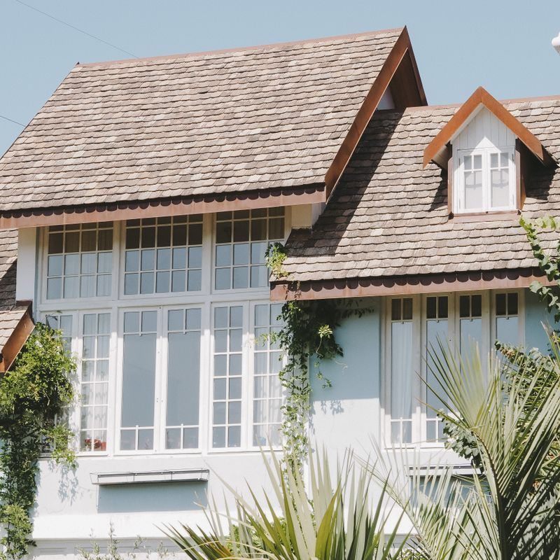 House with large windows and a shingled roof