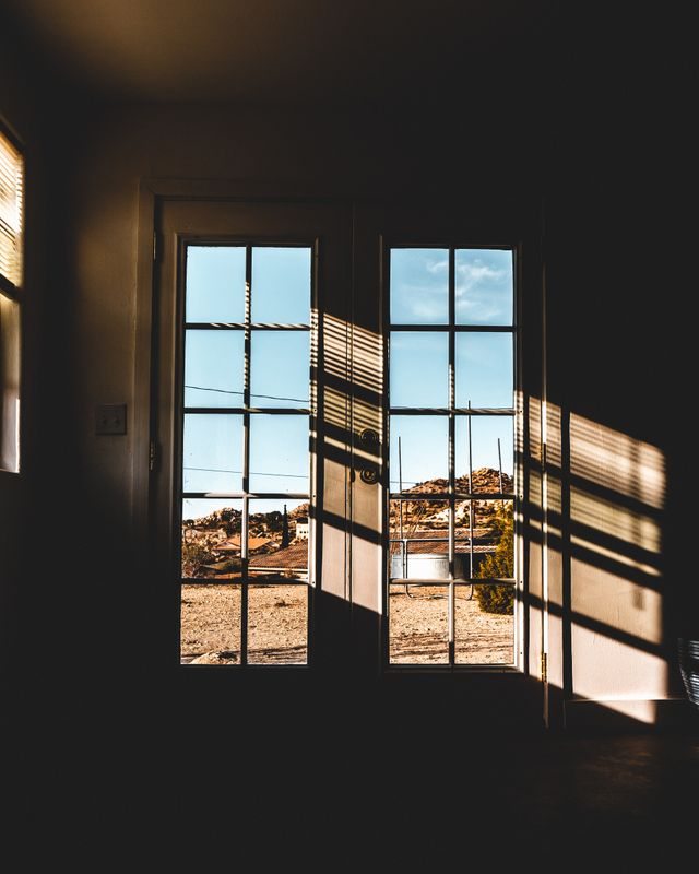 Sunlight casting shadows through a glass door