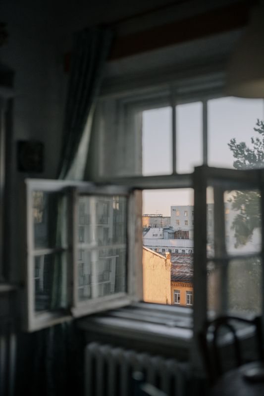 Open timber-framed window viewed from inside a room