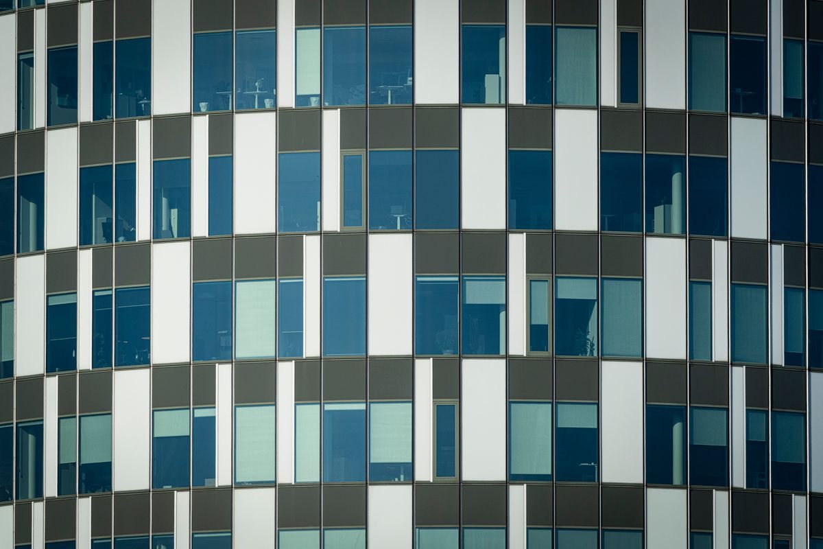 Geometric office facade with rows of glazed windows