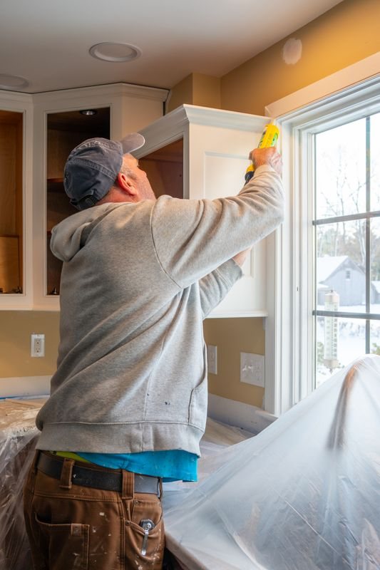 Technician applying a controlled bead of sealant during renovation