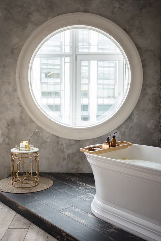 Bathroom interior with a small round daylight window