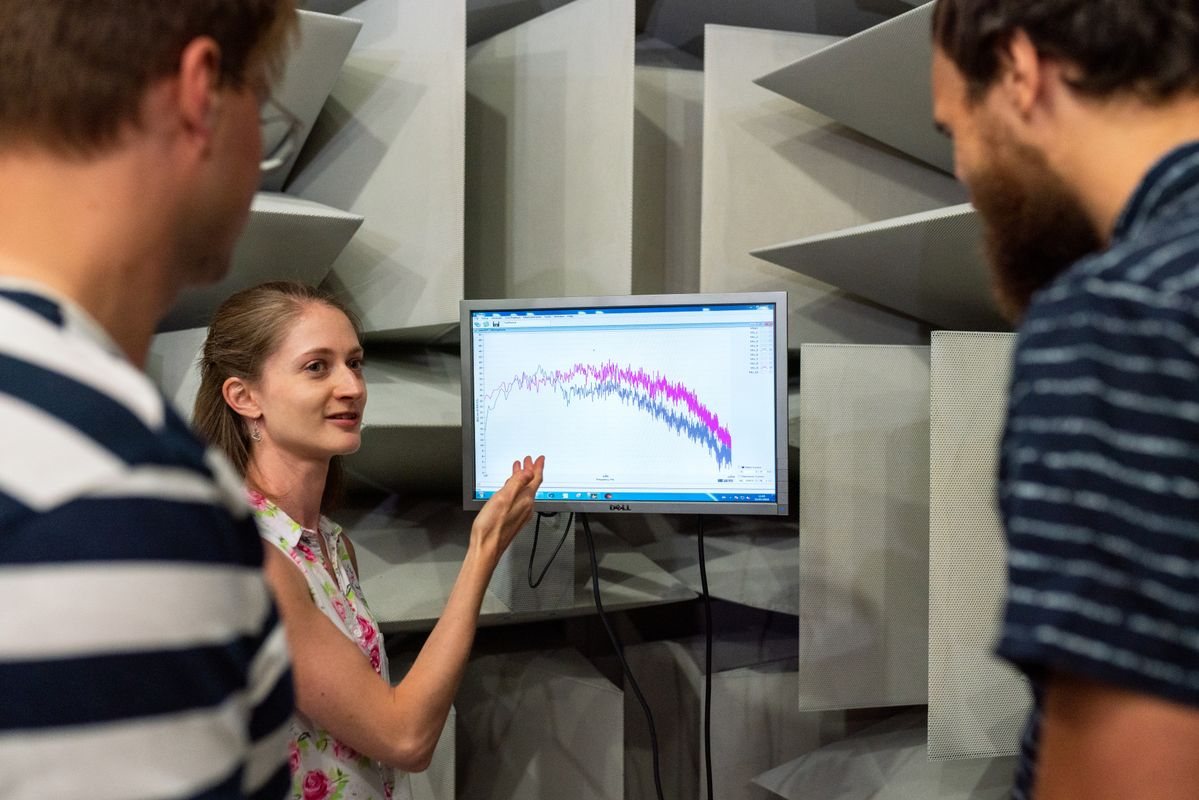 Engineers discussing acoustic measurement data